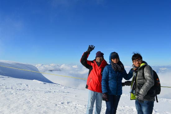 Eurail customer testimonials | Three family looking front on top of the snow mountain in the morning