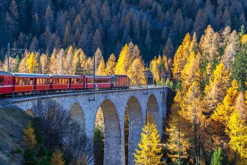 Eurail customer testimonials | Male with a town view with his arms open during the day