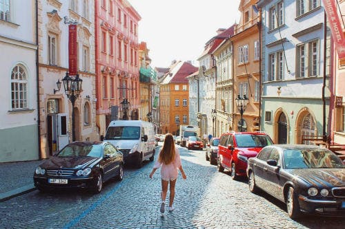Everything about Eurail | Girl in the colorful streets, Prague, Czech Republic