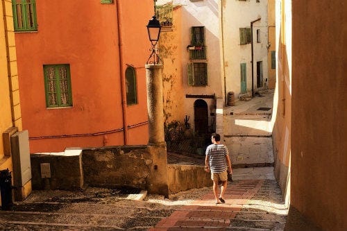 Everything about Eurail | Male walking through the backstreets of a hidden gem of the French Riviera Menton, France
