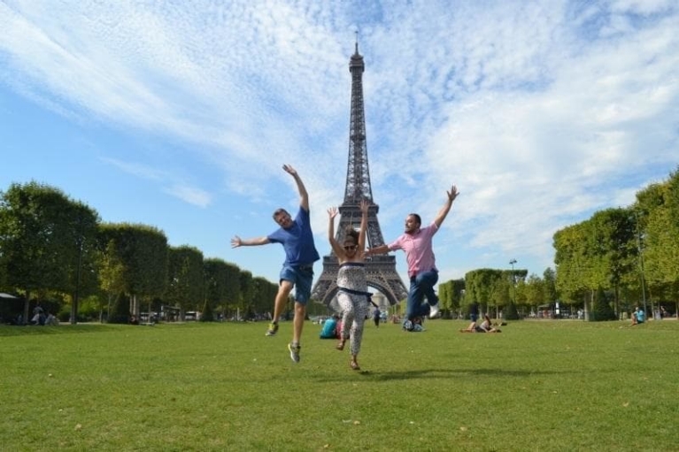Travelers jumping in front of the Eiffel Tower in Paris