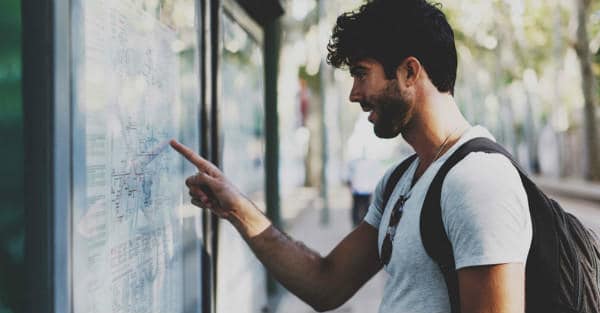 Everything about Eurail | Young bearded traveller man searching for the route in the map